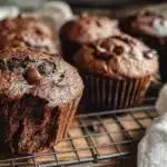 freshly baked chocolate peanut butter banana muffins on a wooden rack