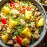 Pineapple chicken fried rice in rustic bowl