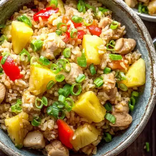 Pineapple chicken fried rice in rustic bowl